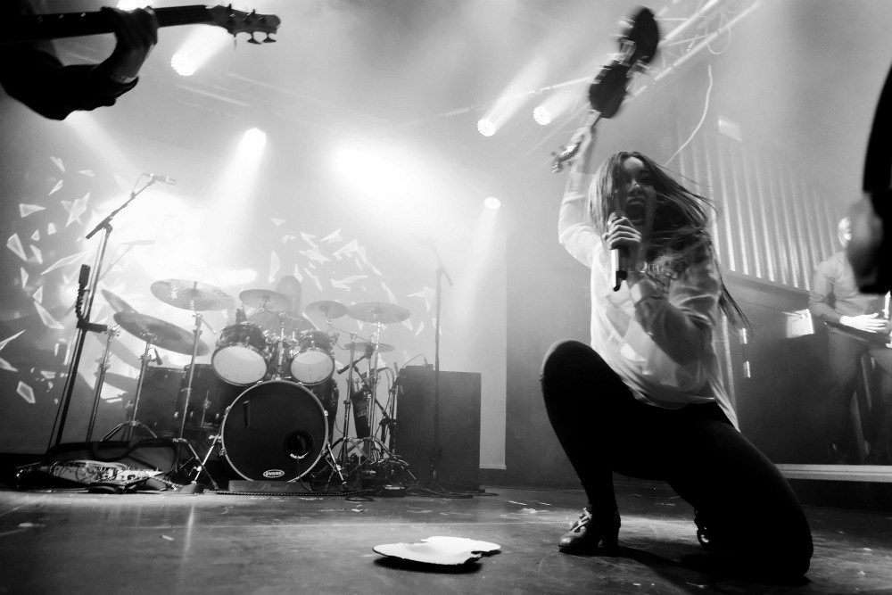 Ethereal Kingdoms live at Royal Metal Fest 2019. Sofia Schmidt shattering a violin at the stage floor. Symphonic metal theatrical performance. Portrait by Jacob Dinesen of Devilution.